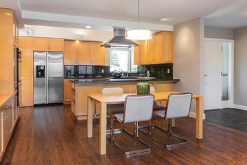 Wooden kitchen with dining table and wooden floor.