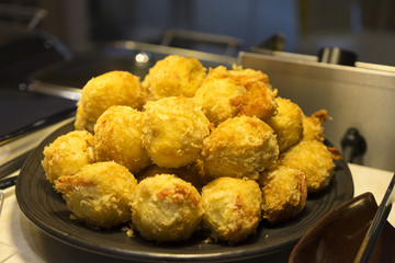 Fried shrimp of ball on black plate