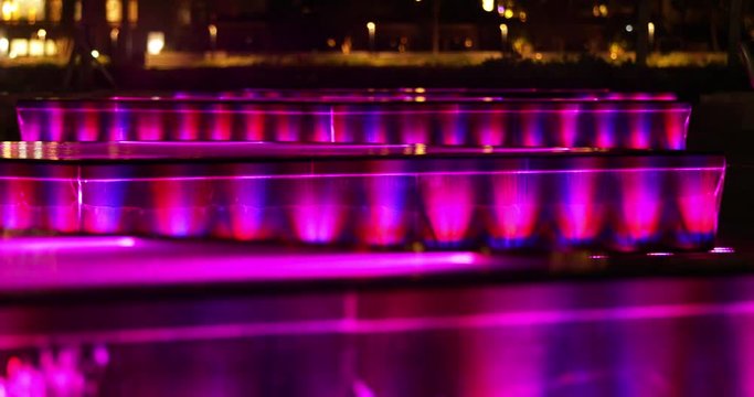 Neon water fountain rack focus back to front