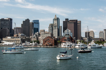 Fototapeta na wymiar Yacht and sailing boats on Charles River in front of Boston Skyline in Massachusetts USA on a sunny summer day