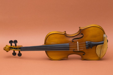 Musical instrument violin on a brown background