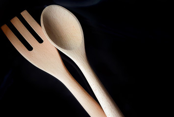 Wooden spoon and wooden fork with dark background