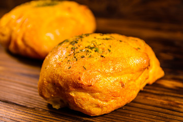 Italian bun ciabatta with garlic on wooden table