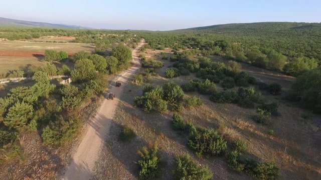Drone shot of dune buggies driving offroad in Croatia in the sunset