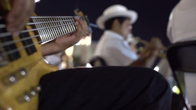 FEBRUARY 27, 2017 Mexico, Campeche. Carnival, dance and parade in colonial town, street musician playing on instrument, close up guitar  from below