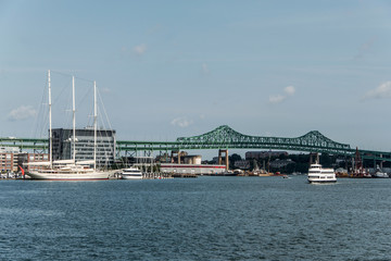 Tobin bridge in Boston MA, USA and the Athena 295 foot yacht docked at the Boston harbor