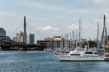 Fototapeta na wymiar Pier 6 with sailboats at Charles River Harbor and Leonard P. Zakim Bunker Hill Memorial Bridge of Boston, USA