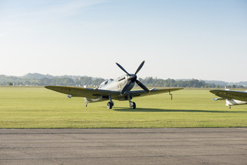 Fototapeta na wymiar Angled Front View of Classic Spitfire Aircraft by a Runway