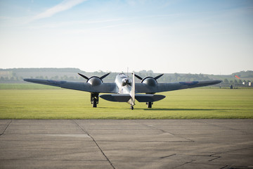 Fototapeta na wymiar Vintage British World War II Bomber Parked by a Runway