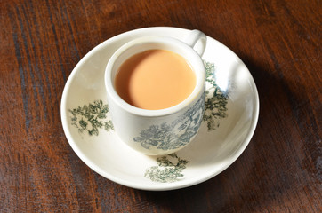 Cup of milk tea on wooden table