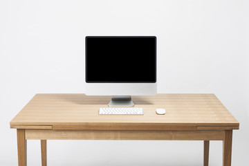 computer on the wood desk isolated on the white background.