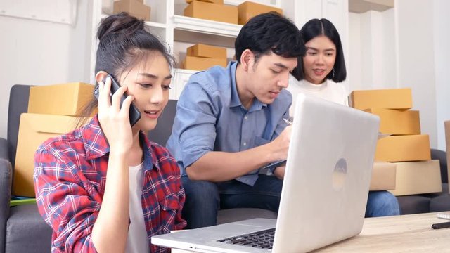 Young Asian People Working at home, Young Owner People Strat up for Business Online, SME, Delivery Project, People with Online Business or SME Concept. Woman Note Order from Customer. 