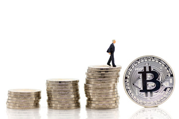 Miniature people : Businessmen standing on a coin stacked increase up respectively, used as a business concept.