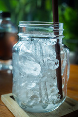 Ice glass on wooden table.