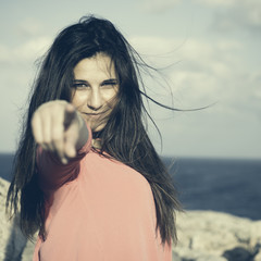 Hey you!. Close up of a 18Y old girl in a rural location indicating the observer 