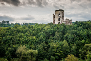Fototapeta premium two towers of the old castle. Ruins of the palace side. Chervonogradsky Castle, Ukraine. Clouds in the sky. 