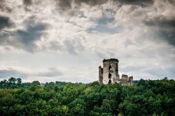 two towers of the old castle. Ruins of the palace side. Chervonogradsky Castle, Ukraine. Clouds in the sky.
