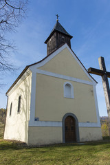 Naklejka premium The front of the church with a bell tower.
