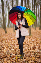 Woman with umbrella in the forest