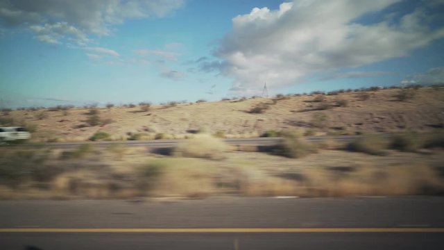 Driving plate side view moving through desert in car
