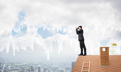 Businessman standing on roof and looking in binoculars. Mixed media