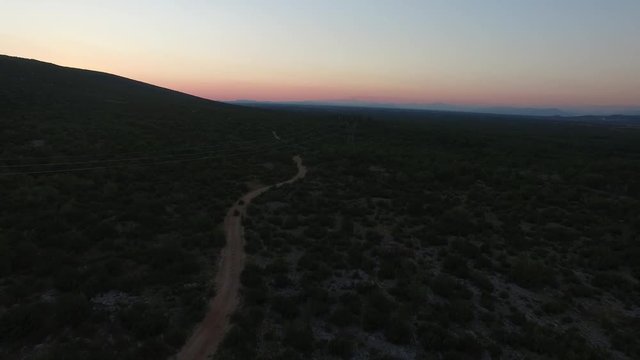 Drone shot of dune buggies driving offroad on a road