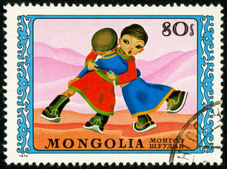 Ukraine - circa 2017: A postage stamp printed in Mongolia shows drawing Wrestle. Series:...