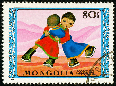 Ukraine - circa 2017: A postage stamp printed in Mongolia shows drawing Wrestle. Series: International Children's Day. Circa 1974.
