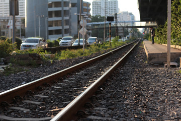 Railroad tracks in Bangkok Thailand with light sunset in evening