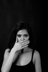 Young beautiful girl closes her mouth. Not talking about SSL, black and white