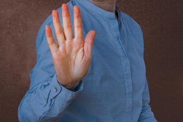 Woman signals defensive attitude with hand