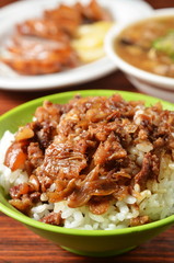 Braised pork rice on wood table