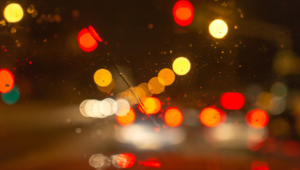 Snow with droplets on the car glass at night