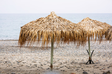 Tropical parasols on empty Maleme beach of Crete, Greece