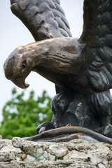 Fototapeta na wymiar The bronze sculpture of an eagle fighting a snake on a Mashuk mountain