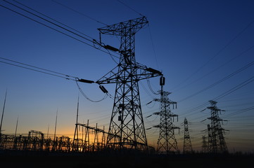 The silhouette of the evening electricity transmission pylon