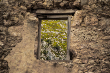 Old window, with mountains behind them