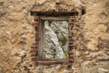 Old window, with mountains behind them