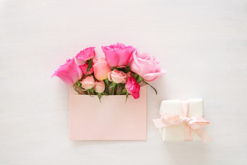 Bouquet of beautiful pink rose flowers in the envelope and giftbox
