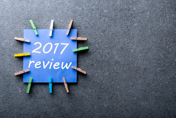 2017 Review, note on blue paper at dark background. Results of the Year, mock up