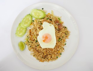 Fried rice on white dish and has fried egg