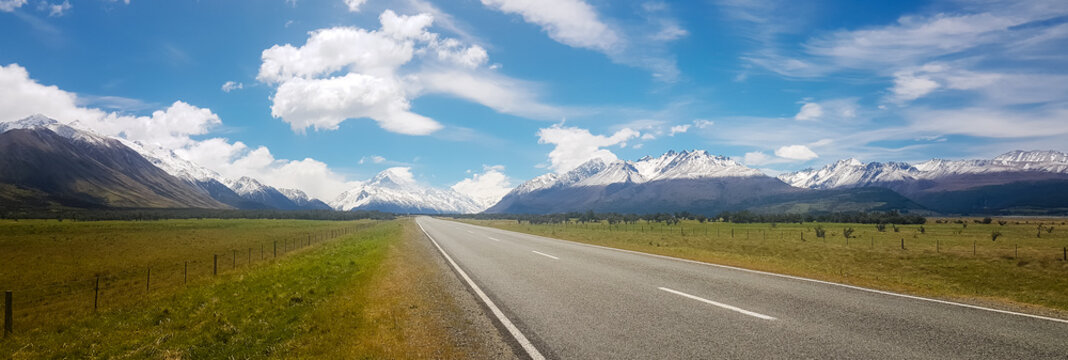 road around beside the beautiful nature and mountains with snow stuck on top of the mountain.It is the landscape and feel fresh and comfortable at the country New Zealand.