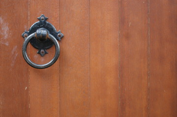 Old fashioned door handle on a wooden church door.