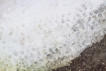 Snow background - Last snow is melting on the sidewalk