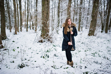 Beautiful brunette girl in winter warm clothing. Model on winter jacket.
