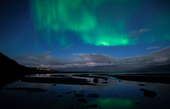 Northern lights background dancing over lake in Abisko national park in Sweden