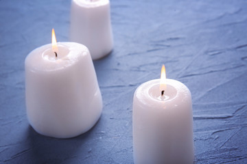 Fototapeta na wymiar Burning candles on table, closeup
