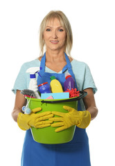 Mature woman with cleaning supplies on white background