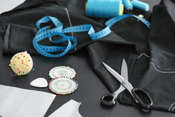 Black fabric and sewing accessories on table