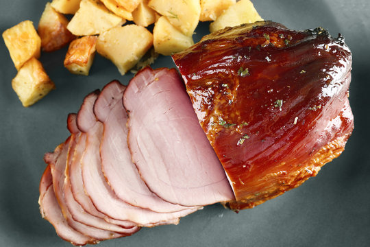 Traditional sliced honey baked ham on plate, closeup